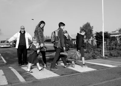 A mum walks to school with her children