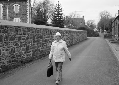 A lady walking home from the village shop