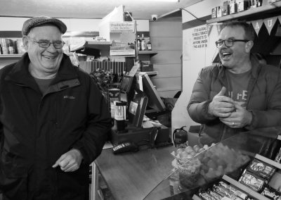 A customer shares a joke with a shop owner