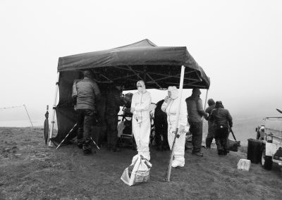 Extras taking cover in a break in filming