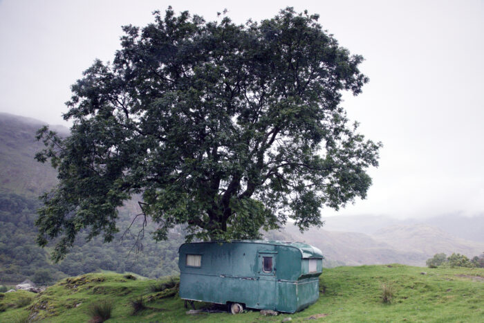 a caravan under a tree in Wales